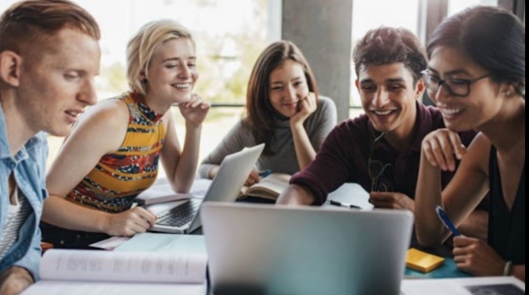 5 students sitting around table