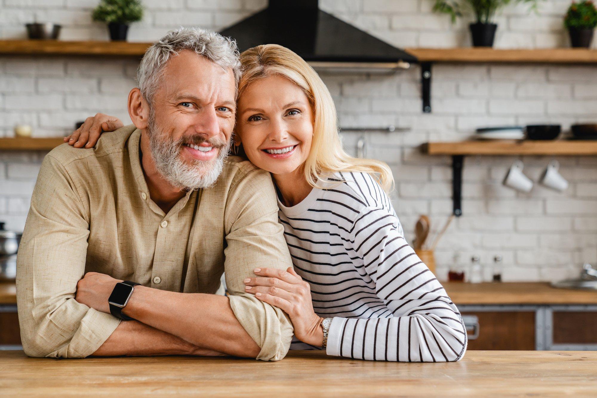 Happy middle-aged couple embracing at home, representing improved intimacy and sexual wellness with Viagra for Women Australia treatment options.